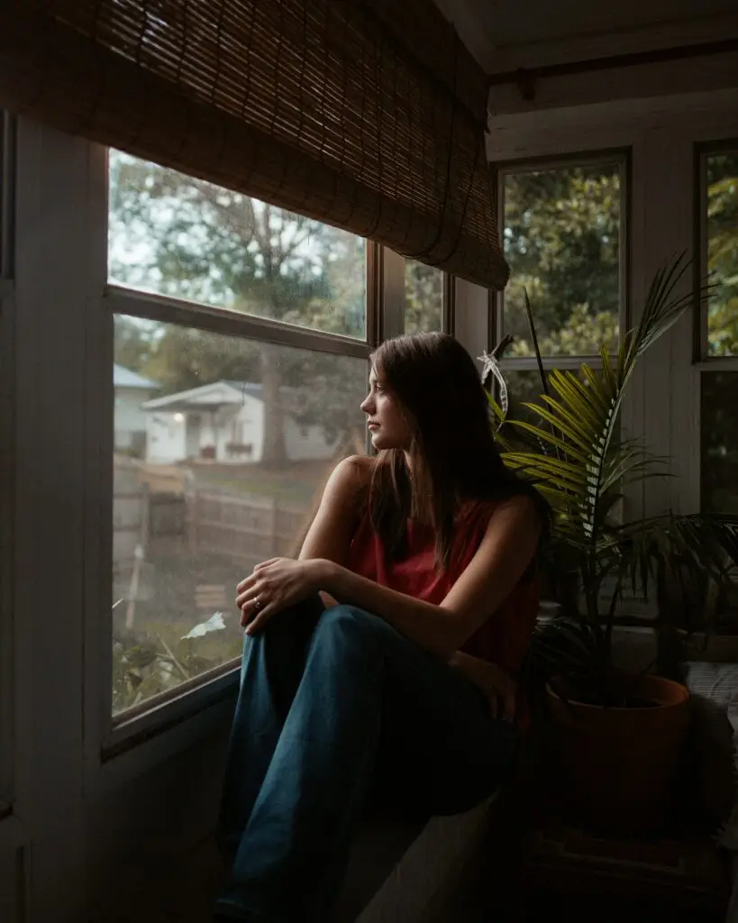 Photo of a women looking out a window